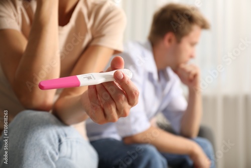 Quadro su tela Couple with pregnancy test at home, selective focus