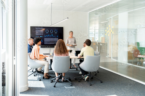 Business team meeting in modern office with interactive whiteboard