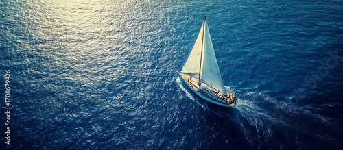 Sailboat Gliding Over Calm Blue Waters During Sunny Daytime