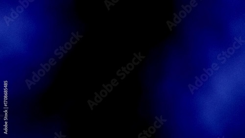 Royal blue smoke flow on black background 4K. Grainy noise, grunge texture. Smooth animation. Bright blue mist cloud effect as frame on dark backdrop for presentation, intro, digital cover, web design