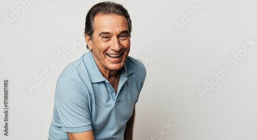 Smiling Mature Man in Blue Polo Shirt Posing for Camera
