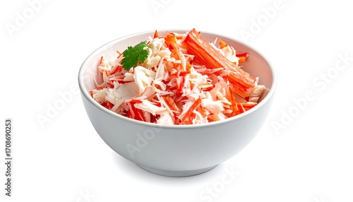 A close-up of a bowl of fresh, colorful crab salad with shreds of white and orange seafood, and a sprig of cilantro