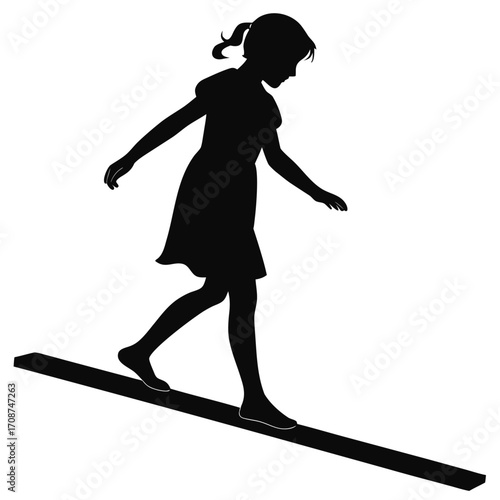 Girl standing on balance beam
