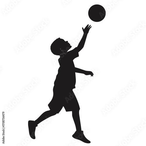Boy tossing ball upward