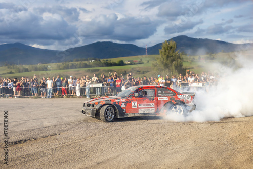 13.09.2025_Slovak car festival_A scene of a drifting car with a smoke screen and a crowd of people in the background