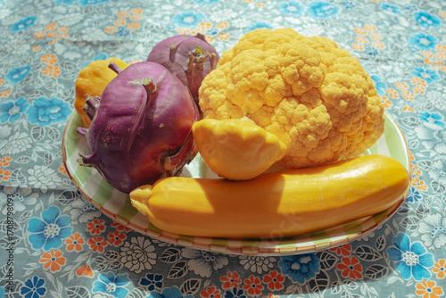Colorful assortment of fresh vegetables on a plate in daylight