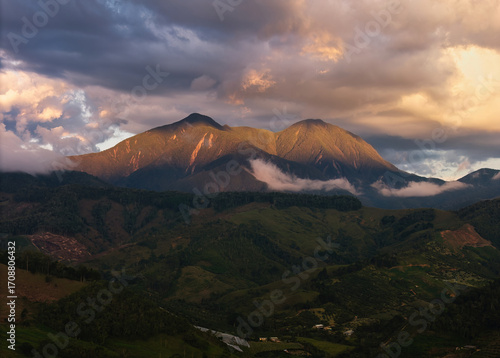 Warm sunlight illuminating mountain peaks of San Jose Hill in Urrao.