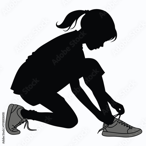 Girl crouching to tie shoelace