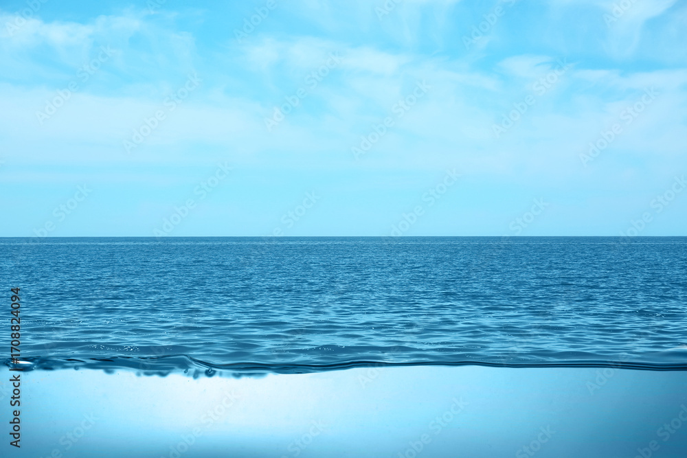 Fototapeta premium Sea water surface and underwater view. Sky with clouds above