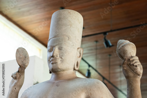 Ancient khmer stone vishnu statue holding chakra and conch in phnom penh, cambodia
