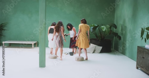 Four women gathering for tea in a nature-inspired studio