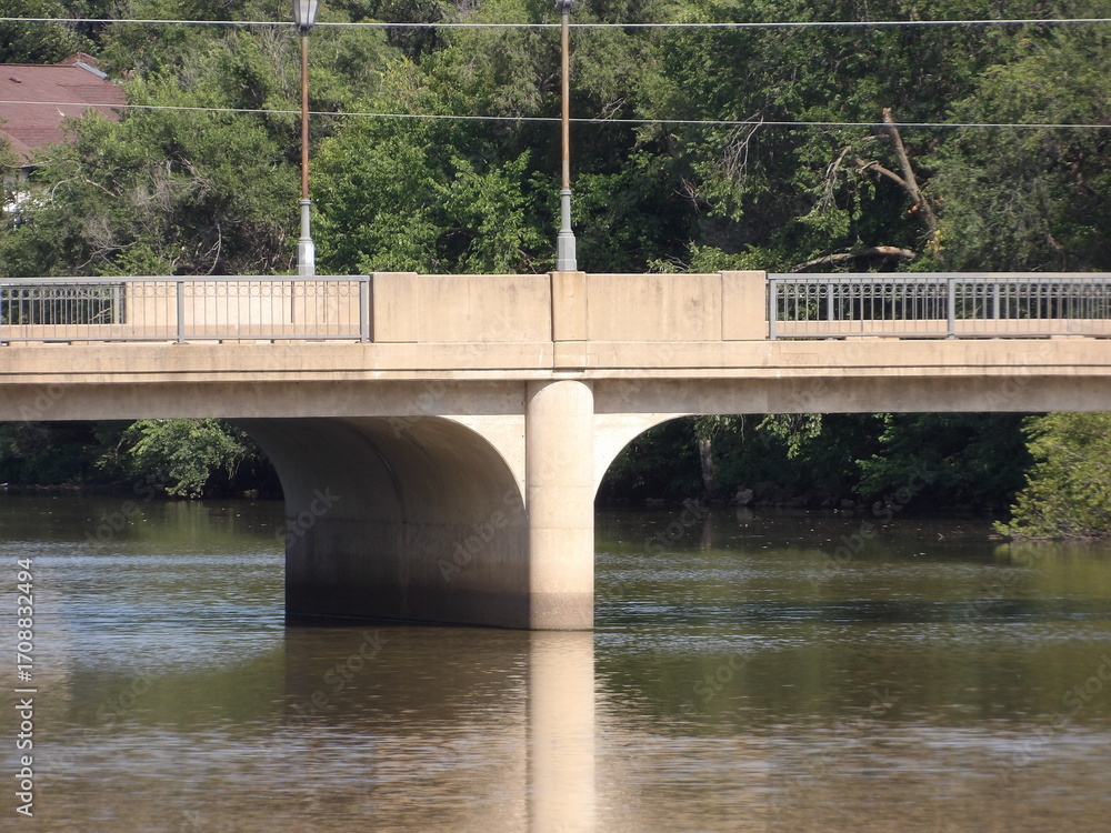 Fototapeta premium Concrete Bridge Spanning Over Tranquil River