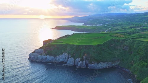 Cape Furado, Cliffs, Green Lush Fields, Pasturelands and Atlantic Ocean at Sunrise. Azores, Sao Miguel Island. Portugal. Aerial View. Drone Moves Forward