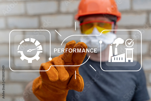 Industrial worker using virtual touch screen presses the word PERFORMANCE. Performance, Productivity, Efficiency Industry concept.