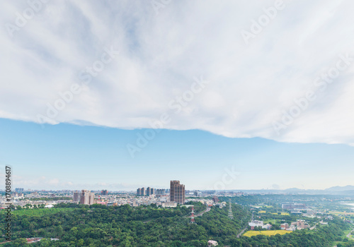 Morning Town View with Green Hills and Wide Sky