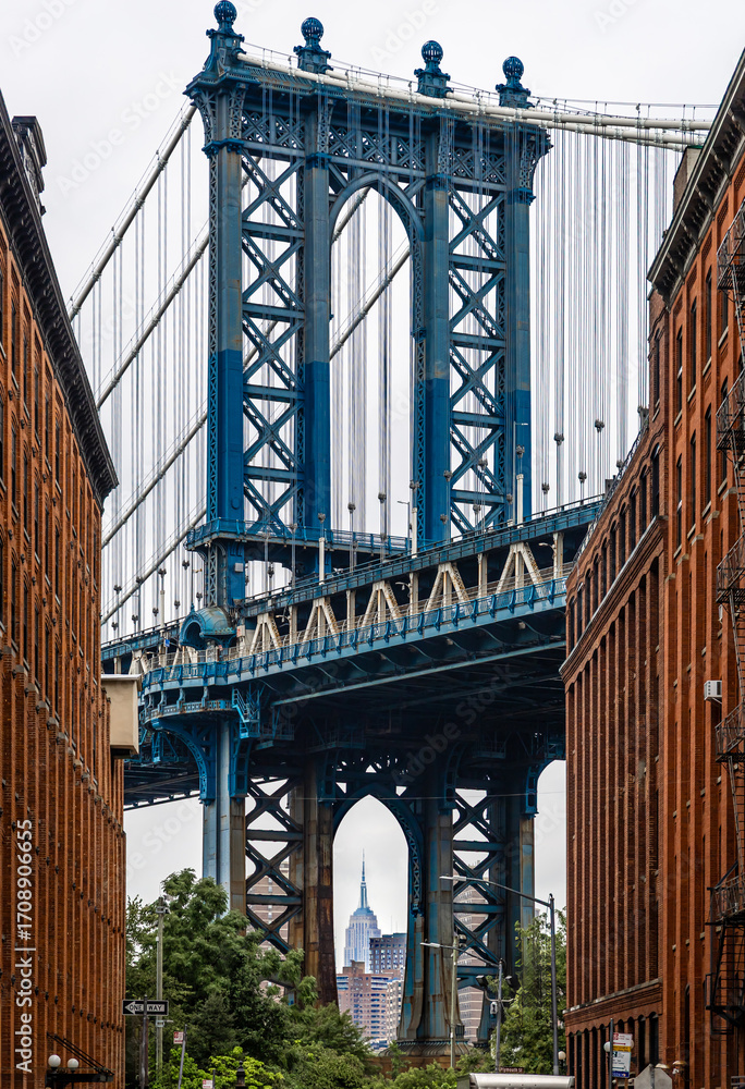 Fototapeta premium Manhattan Bridge view framed by red brick buildings in DUMBO Brooklyn