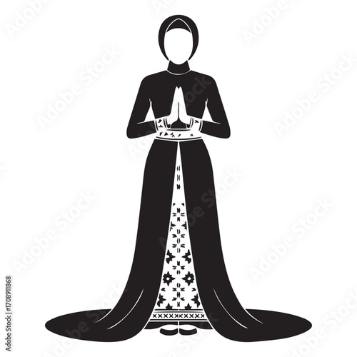 Elegant silhouette of a woman in a long flowing black dress and headscarf praying with hands clasped in devotion