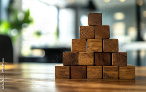Wooden Blocks Stacked in Pyramid Shape on Table, Business Concept, Strategy