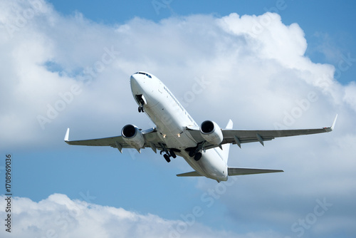 Εκτύπωση καμβά White plane climbing higher against the clouds
