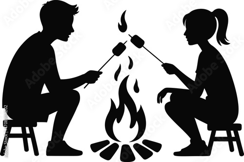 Couple enjoying roasting marshmallows around a campfire silhouette