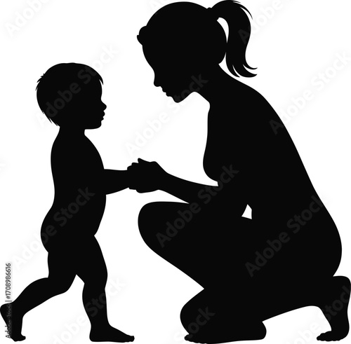 Mother gently guides toddler taking first steps silhouette