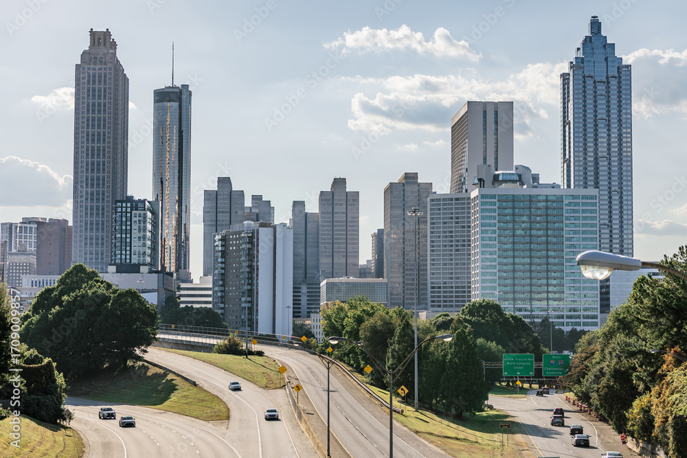 Fototapeta premium View of the Midtown, Downtown Atlanta Skyline showing several prominent buildings, highways, cars, light trials and hotels just prior to sunset.