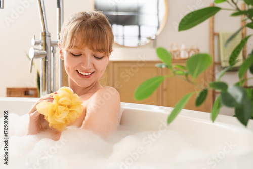 Young woman taking bath wit...