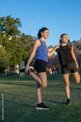 Slim teenage girls stretching outdoors with healthy lifestyle concept.Suitable for sports campaigns, healthy outdoor living. Concept of young people playing sports.
