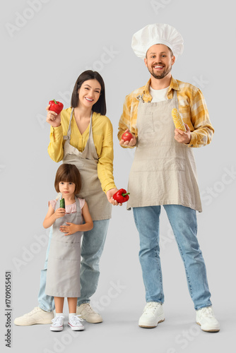 Happy family in aprons with...