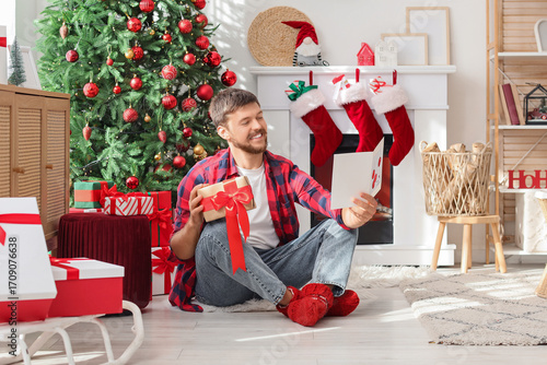 Young man with gift reading...
