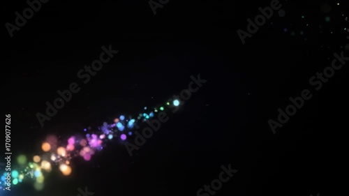 Abstract colorful glowing particles shimmer and fade across the screen in an endless loop, creating a vibrant sparkle effect smooth transition, presentation, overlay