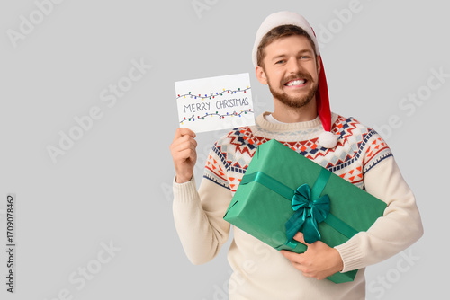 Happy young man in Santa ha...
