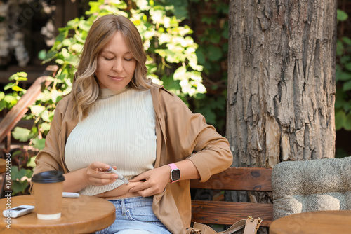 Diabetic woman using lancet...
