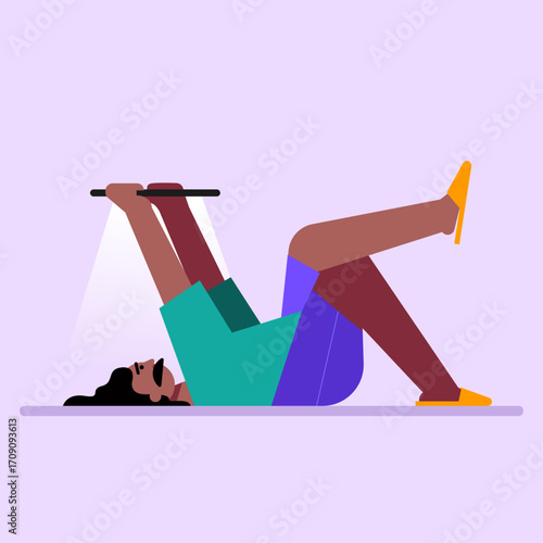 Man lying on the floor comfortably using a digital tablet device.