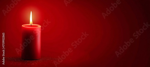 Burning red candle casting a warm glow on a dark red background, creating a cozy and inviting atmosphere
