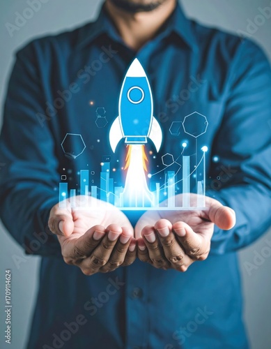 Hands holding a stylized blue rocket taking off amidst blue chart graphics, symbolizing startup success and technological advancement