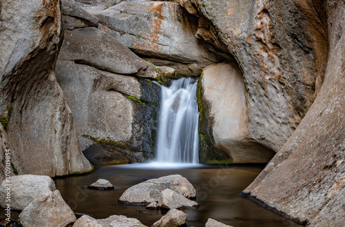 Papier peint Secret hidden waterfall in a narrow rocky canyon with a long exposure capture