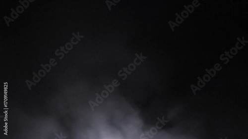 Ethereal white smoke and mysterious fog effect against a dark black background, ideal for overlays