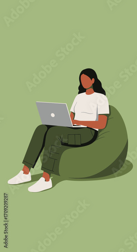 Young woman comfortably works on laptop, sitting on a bean bag. Ideal for remote work, casual productivity, and modern lifestyle concepts.
