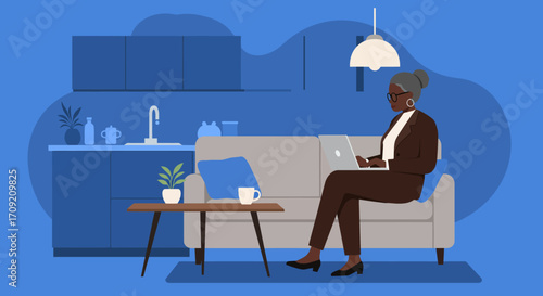 Mature Black businesswoman working from home on her laptop in a modern, comfortable interior. Depicts remote work, productivity, and contemporary lifestyle.