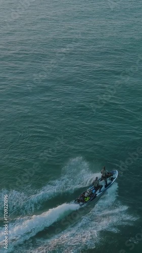 Wallpaper Mural Aerial view of divers speeding on a jet ski with diving equipment in tow. They are heading to a dive site for underwater exploration. Torontodigital.ca