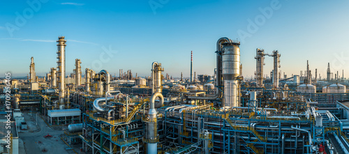 Wallpaper Mural A large oil refinery and petrochemical plant with complex industrial equipment at sunset Torontodigital.ca