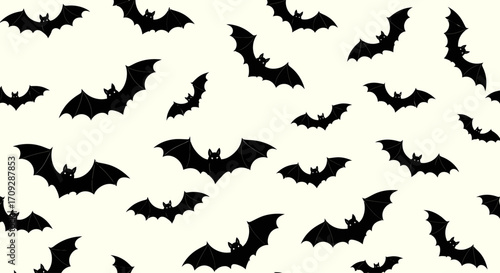 Seamless pattern of flying black bats on a light background, perfect for Halloween designs and spooky themes.