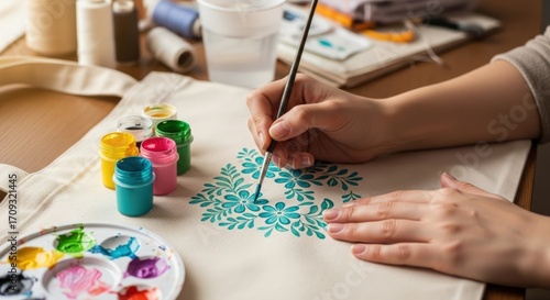 Woman's Hands Painting Floral Design on Canvas Tote Bag with Acrylic Paint