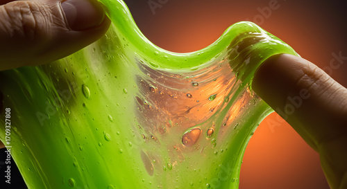 Green slime being stretched between fingers