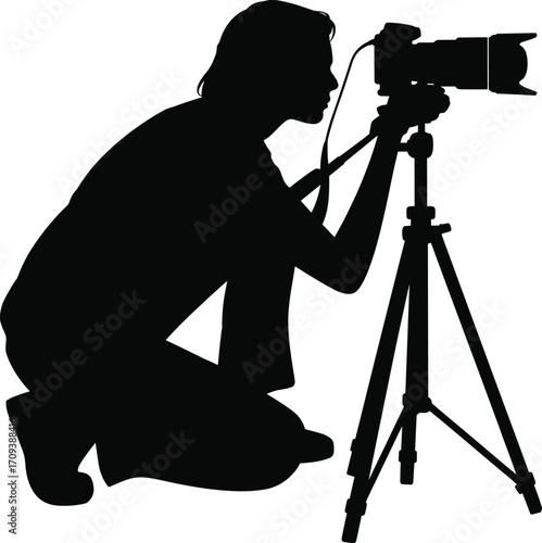 Silhouette of Female Photographer Kneeling with DSLR Camera on Tripod Capturing Photo – Ideal for Creative and Editorial Use