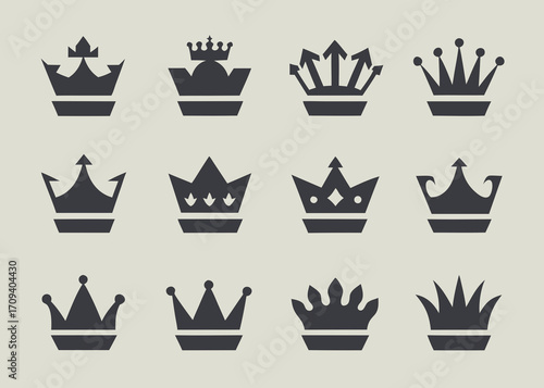 Collection of twelve dark gray crown icons on a light gray background
