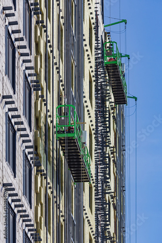 Construction baskets for work on the facade of a multi-storey building under construction