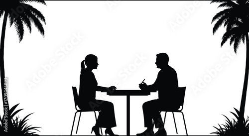 Silhouette of a couple enjoying a romantic dinner by palm trees