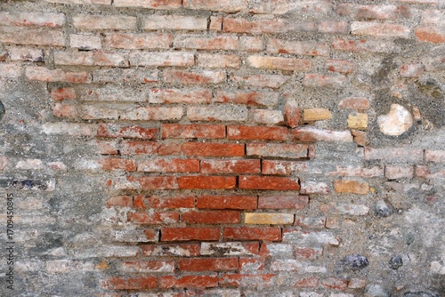 old brick wall, small and large bricks, pink shade